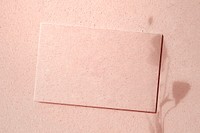 Blank card on a pink concrete