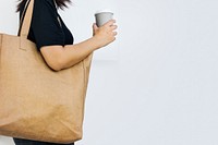 Environmentalist woman using eco-friendly tote bag photo with design space