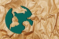Green earth on ripped brown paper craft background