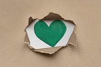 Green heart inside eco-friendly brown torn kraft paperboard