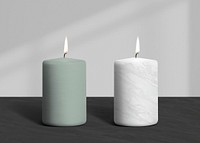 Lit scented candles in green and white marble design