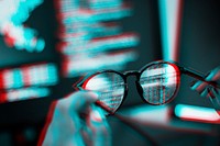 Hand holding futuristic smart glasses in double color exposure effect