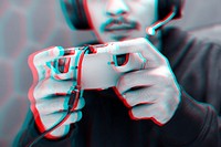 Professional eSport gamer playing a game with gaming controller in double color exposure effect