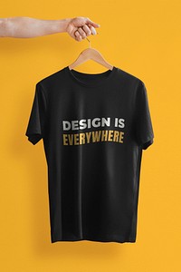 Simple t-shirt mockup psd in black with hand holding hanger