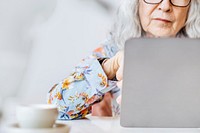 Social media networking background with senior woman working on a laptop