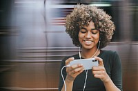 Woman holding smartphone psd remixed media in the subway