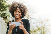 Woman holding smartphone psd remixed media with nature view