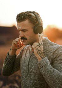 Man wearing wireless headphones psd remixed media