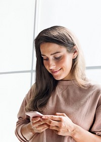 Smiling woman holding smartphone in the office remixed media