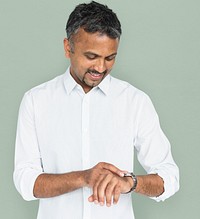 Mature man checking time on his wristwatch