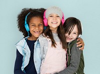 Group of Little Girls Studio Smiling Wearing Headphones and Winter Clothes