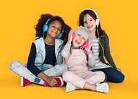 Group of Little Girls Studio Smiling Wearing Headphones and Winter Clothes