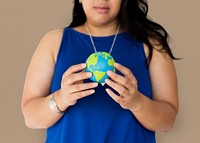 Portrait of a woman holding a small globe