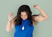 Portrait of a woman with eyes closed and arms raised