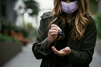 Woman using a hand sanitizer during coronavirus pandemic