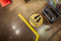 Supermarket social distancing sign on the ground during coronavirus pandemic