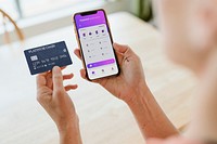 Woman using a mobile phone mockup to shop online during coronavirus pandemic