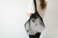 Woman with tissue papers in a net bag