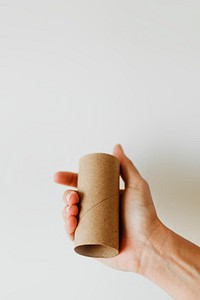 Woman holding an empty toilet paper roll during coronavirus pandemic
