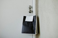 Black paper bag on a door knob during the coronavirus outbreak 