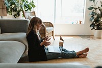 Woman working from home using a laptop screen mockup