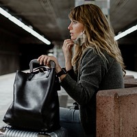 Woman with a suitcase waiting for the train during the coronavirus pandemic 