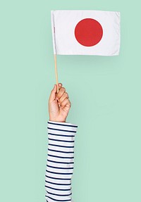 Hand holding Japan flag isolated