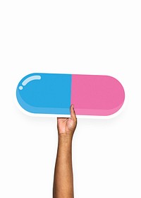 Hand holding a pill cardboard prop