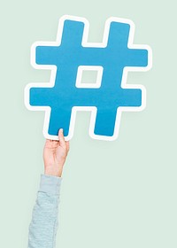 Hand raised holding hashtag icon