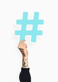 Hand with tattoo holding hashtag icon