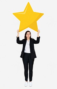 Businesswoman holding a golden star rating symbol