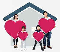 Happy family holding a heart shaped icon
