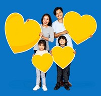 Happy family holding heart shapes
