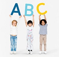 Diverse happy kids holding the ABC