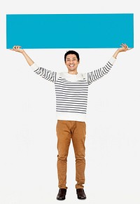 Cheerful man holding a blank blue banner