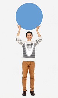 Cheerful man holding a blank blue circle