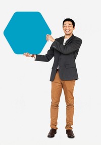Cheerful man showing a blank blue hexagon shaped board