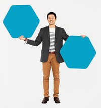 Cheerful man showing blue hexagon shaped boards
