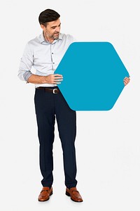 Cheerful man showing a blank blue hexagon shaped board