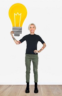 Happy woman holding a light bulb icon