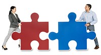 Business people connecting jigsaw puzzle pieces