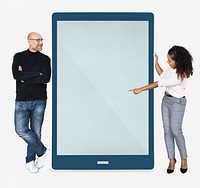 Cheerful people pointing at a tablet screen