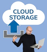 Man carrying a laptop and a cloud storage icon