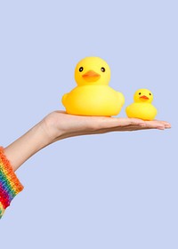 Cute rubber ducks on a hand