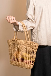 Woman using a net bag to carry fruits