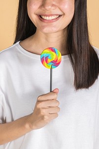 Happy woman with a rainbow lollipop