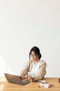 Studious Asian woman working at home using a laptop 