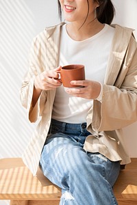 Asian woman with a cup of coffee in her hand