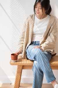 Asian woman with a cup of coffee in her hand