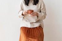 Asian woman with a cup of coffee in her hand